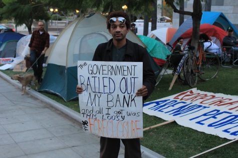 A man protests the distribution of wealth at a similar protest in Los Angeles. Credit: Ben Gill for The Foothill Dragon Press